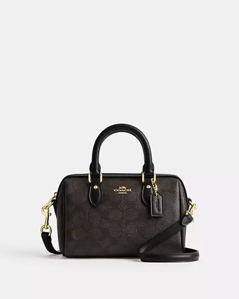 Coach Mini Rowan Crossbody Bag in Signature Canvas, detailed with a playful gold-tone chain charm strap and a structured, compact silhouette with box