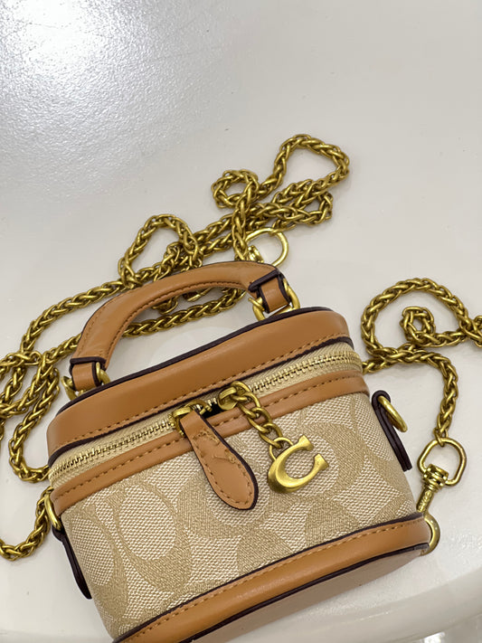 Coach Trail Crossbody 12 in signature canvas, featuring a structured vanity-style silhouette accented with a gold-tone Coach "C" zipper pull