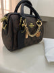 Coach Mini Rowan Crossbody Bag in Signature Canvas, detailed with a playful gold-tone chain charm strap and a structured, compact silhouette with box