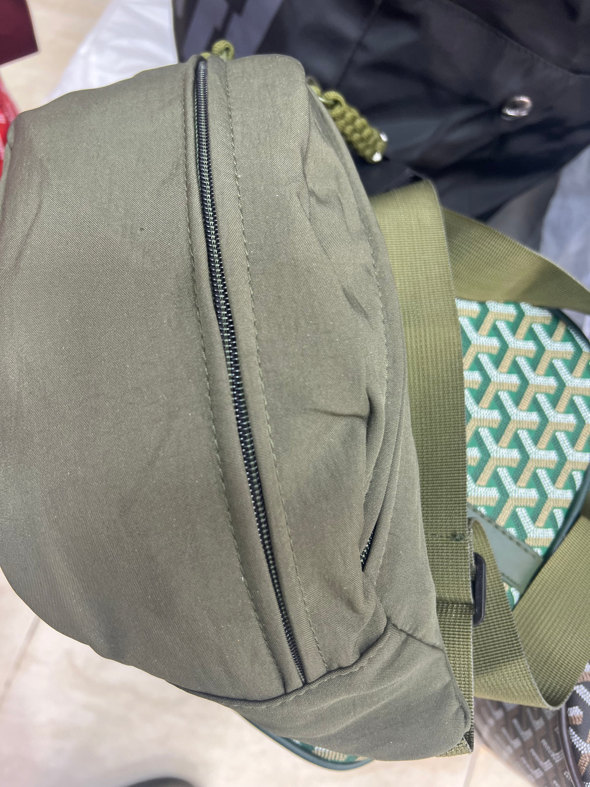 Nylon fanny pack with double zippered compartments and braided zipper pulls.