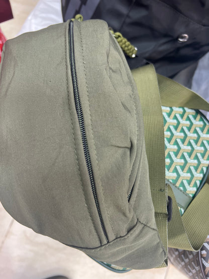 Nylon fanny pack with double zippered compartments and braided zipper pulls.