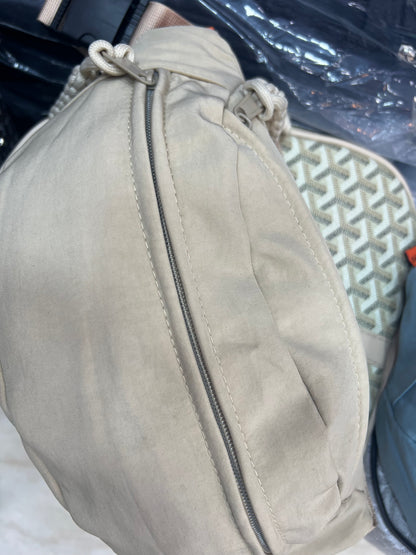 Nylon fanny pack with double zippered compartments and braided zipper pulls.
