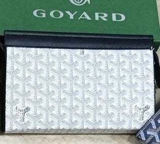 Goyard Chypre wallet on strap featuring the iconic chevron Goyardine coated canvas and a matching detachable small pouch