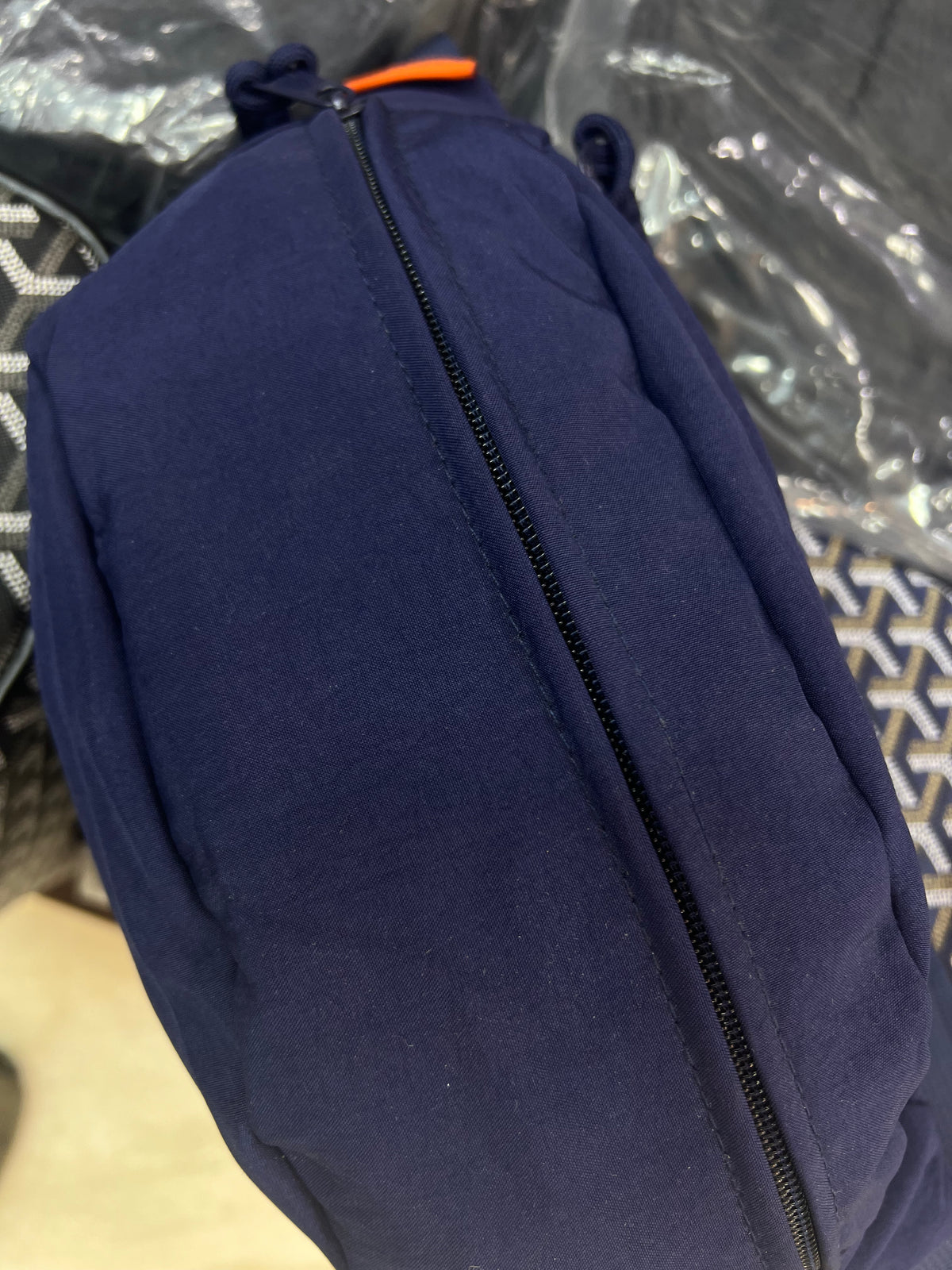 Nylon fanny pack with double zippered compartments and braided zipper pulls.