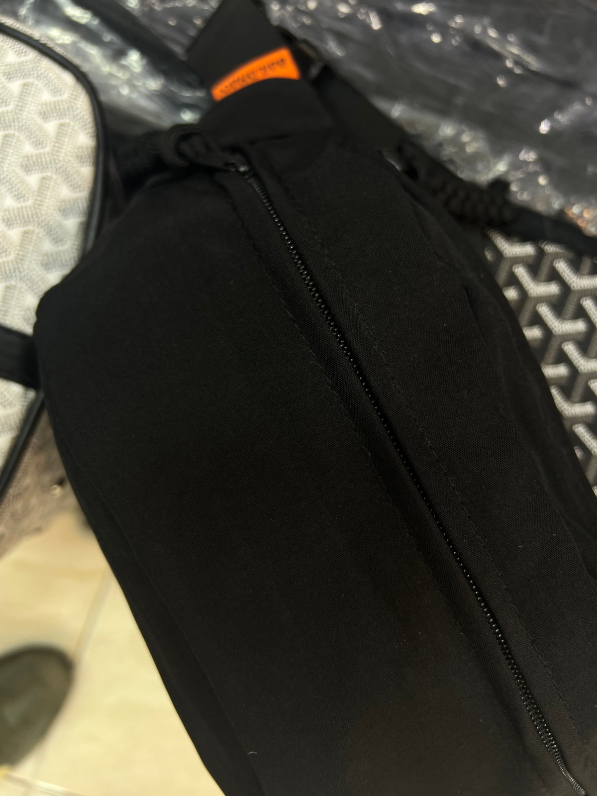 Nylon fanny pack with double zippered compartments and braided zipper pulls.