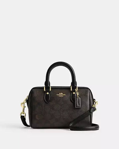 Coach Mini Rowan Crossbody Bag in Signature Canvas, detailed with a playful gold-tone chain charm strap and a structured, compact silhouette with box