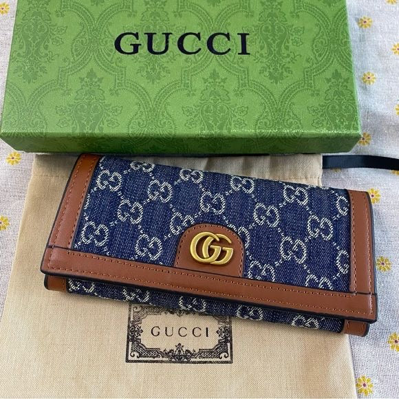 long blue GG monogram denim wallet accented with tan leather trim and a gold-tone interlocking G logo