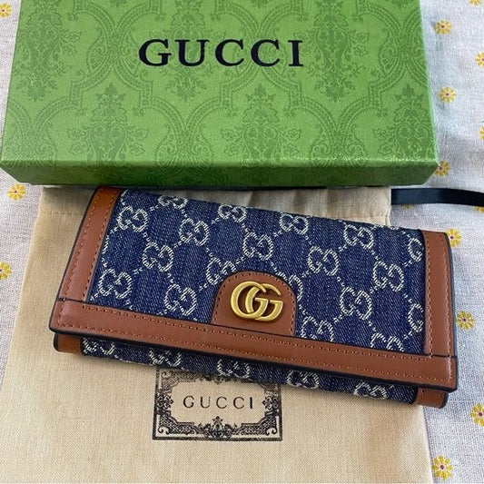 long blue GG monogram denim wallet accented with tan leather trim and a gold-tone interlocking G logo