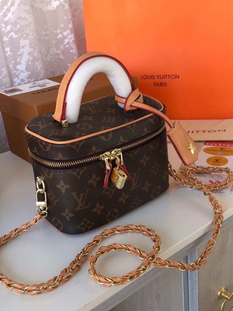 Louis Vuitton Vanity PM crafted in the iconic Monogram coated canvas with a top handle, gold-tone zipper, and a small padlock