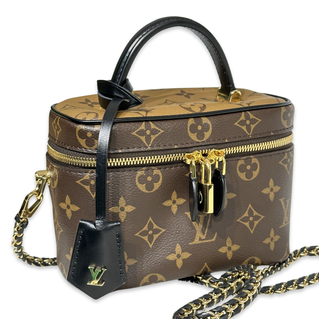 Louis Vuitton Vanity PM crafted in the iconic Monogram coated canvas with a top handle, gold-tone zipper, and a small padlock