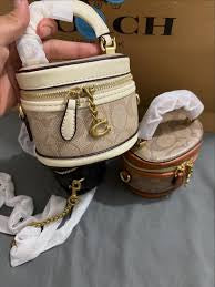 Coach Trail Crossbody 12 in signature canvas, featuring a structured vanity-style silhouette accented with a gold-tone Coach "C" zipper pull