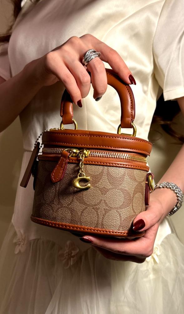 Coach Trail Crossbody 12 in signature canvas, featuring a structured vanity-style silhouette accented with a gold-tone Coach "C" zipper pull