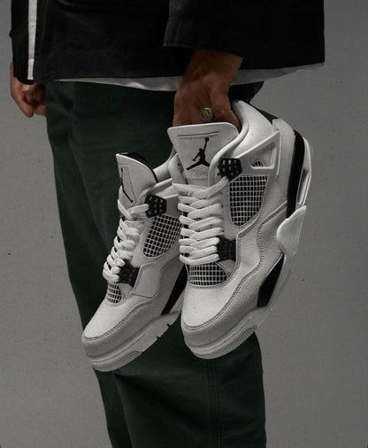 Air Jordan 4 Retro "Military Black" sneakers, highlighted by their crisp white leather upper and contrasting neutral grey mudguard