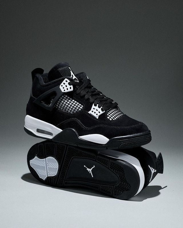 Air Jordan 4 "White Thunder" sneakers, featuring a sleek black nubuck upper contrasted by crisp white mesh accents