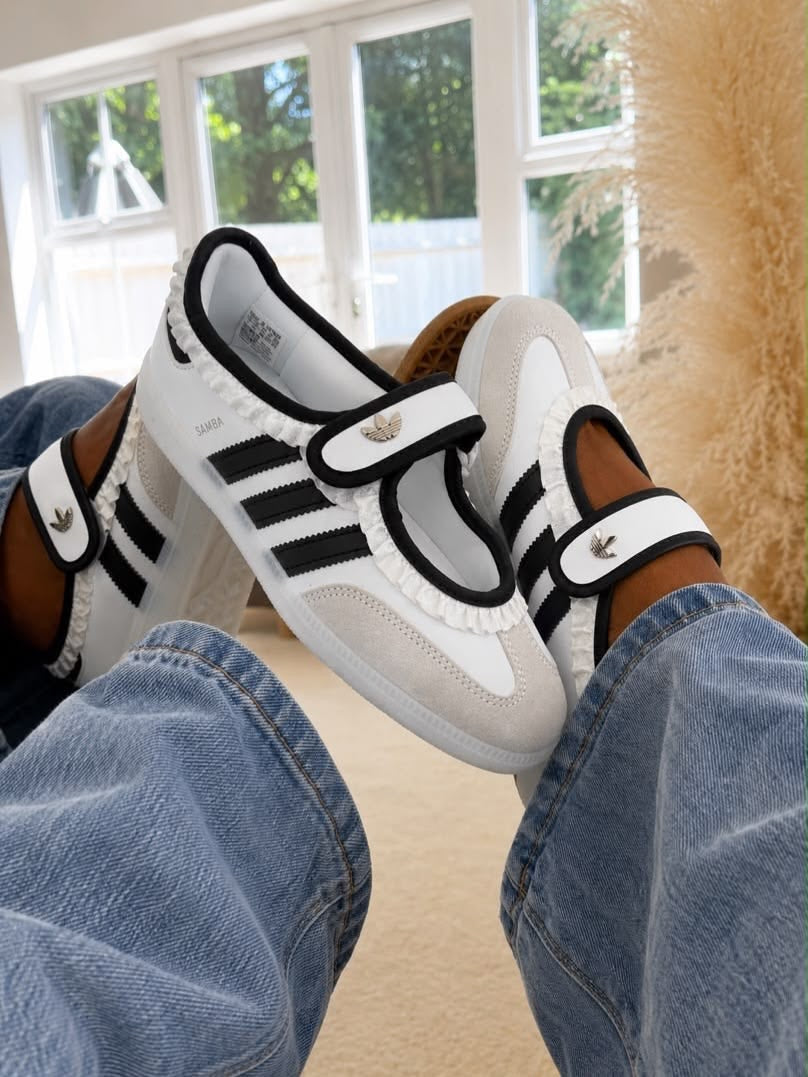 Samba Jane sneakers in white and black, featuring a distinctive midfoot strap and delicate ruffled trim