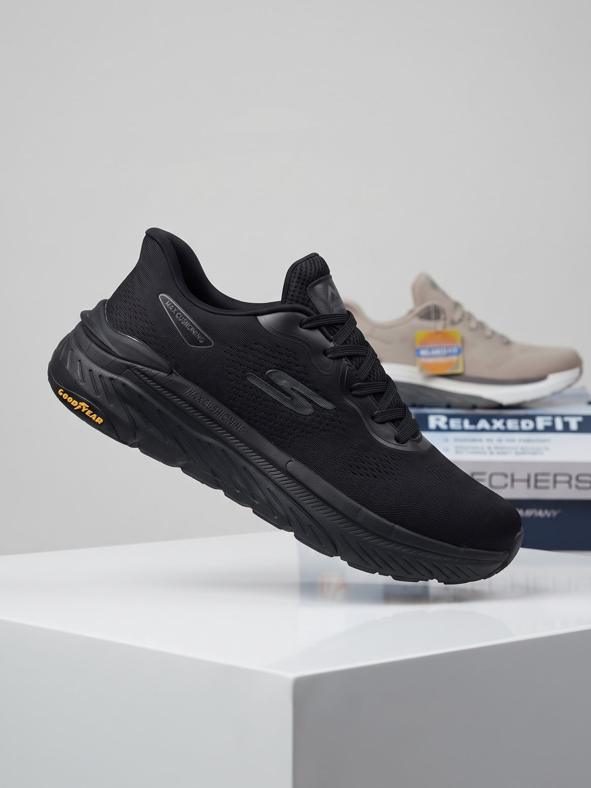 Skechers Max Cushioning athletic shoe featuring bright orange accents and a durable Goodyear rubber outsole