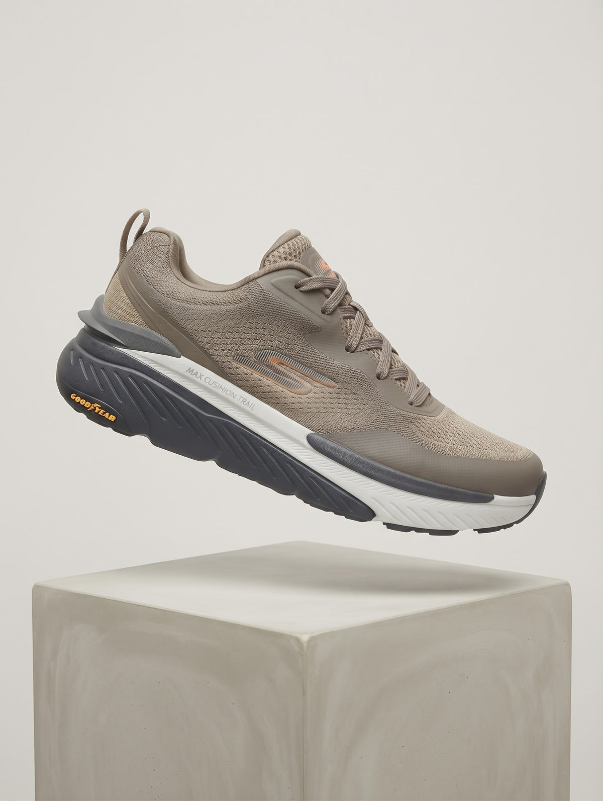 Skechers Max Cushioning athletic shoe featuring bright orange accents and a durable Goodyear rubber outsole