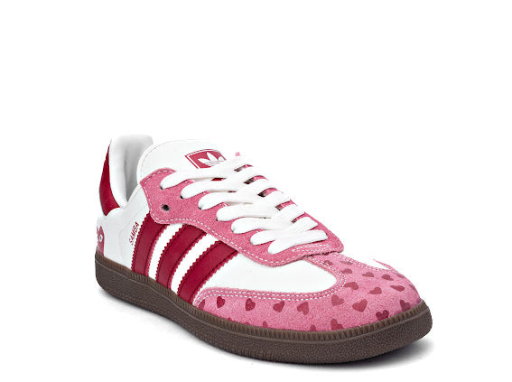 Samba Love x Comme Des Garçons sneaker featuring a white and pink leather upper with a heart