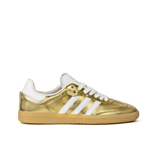 Samba OG sneakers feature a luxurious cracked metallic gold leather upper with white serrated stripes