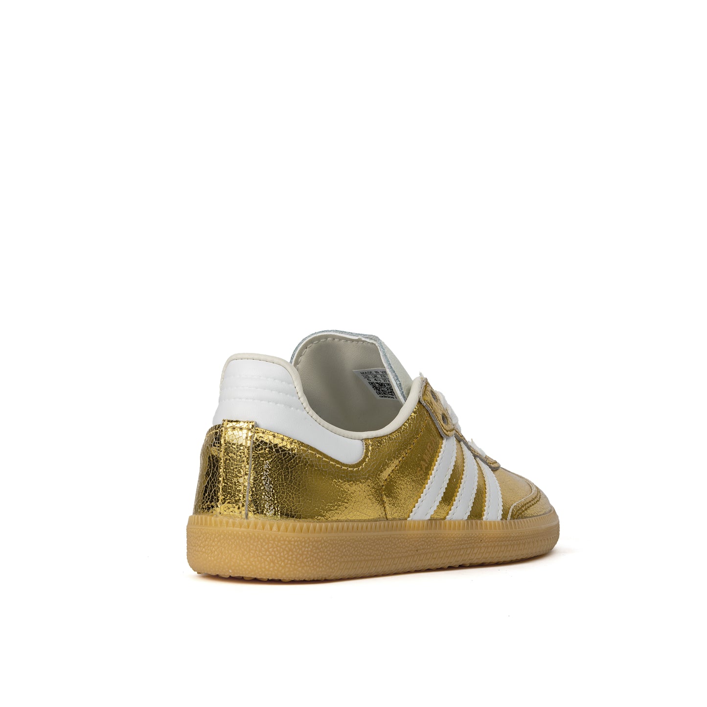 Samba OG sneakers feature a luxurious cracked metallic gold leather upper with white serrated stripes