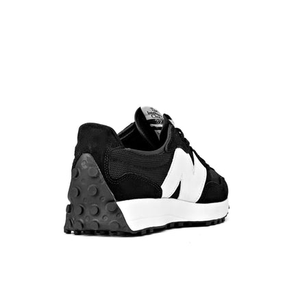 NB 327 sneakers in black and white, featuring a signature oversized 'N' logo and a trail-inspired rubber