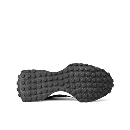 NB 327 sneakers in black and white, featuring a signature oversized 'N' logo and a trail-inspired rubber