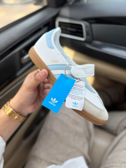 Samba Jane White-sky sneakers feature a distinctive halo blue striped design and a secure hook-and-loop strap