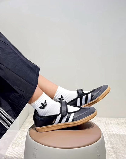 Samba Jane Black shoes feature a classic leather upper and a modern Mary Jane strap aesthetic