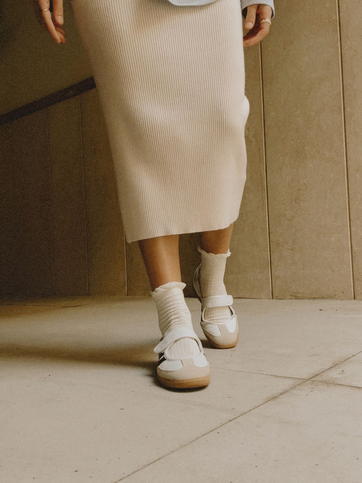 Samba Jane shoes featuring a white leather upper, black stripes, and a velcro strap