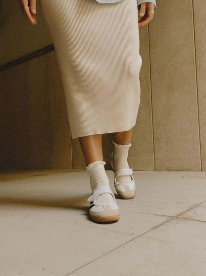 Samba Jane shoes featuring a white leather upper, black stripes, and a velcro strap