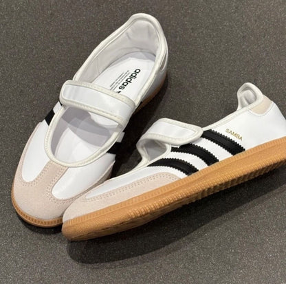 Samba Jane shoes featuring a white leather upper, black stripes, and a velcro strap
